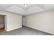 Main bedroom with tray ceiling and grey carpet at 1299 Paddocks Way, Powder Springs, GA 30127