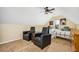 Bright bonus room with two twin beds, seating, and a ceiling fan at 1358 Fallsbrook Way, Acworth, GA 30101