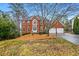 Brick two-story house with attached garage and landscaped yard at 1358 Fallsbrook Way, Acworth, GA 30101