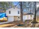 Two-story house with white siding, stone accents, and a garage at 708 Martin Rd, Stone Mountain, GA 30088