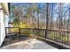 Private patio with wooded views and a black railing at 708 Martin Rd, Stone Mountain, GA 30088