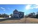 Two-story home with a gray and stone exterior and a landscaped front yard at 5257 Shorthorn Way, Powder Springs, GA 30127