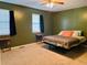 Green bedroom with a bed, two nightstands, and two windows at 2711 Greystone Ct, Austell, GA 30106