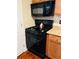 Close-up of the black gas stove and microwave in the kitchen at 2711 Greystone Ct, Austell, GA 30106