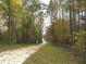 Paved trail through a wooded area in autumn at 2711 Greystone Ct, Austell, GA 30106