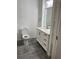 Clean and bright bathroom showcasing white vanity, modern fixtures, and gray tile flooring at 1880 Hays Farm Walk, Marietta, GA 30064