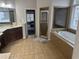 Large primary bathroom featuring double vanities, a soaking tub, and separate shower at 1880 Hays Farm Walk, Marietta, GA 30064
