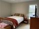 Cozy bedroom with a comfortable bed, nightstand, and a window offering natural light at 1880 Hays Farm Walk, Marietta, GA 30064