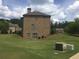 Side view of a two-story brick home with a grassy backyard at 1880 Hays Farm Walk, Marietta, GA 30064