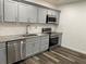 Modern kitchen with gray shaker cabinets, stainless steel appliances, and granite counters at 1880 Hays Farm Walk, Marietta, GA 30064