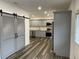 Modern kitchen featuring gray shaker cabinets, stainless steel appliances, and sliding barn doors at 1880 Hays Farm Walk, Marietta, GA 30064