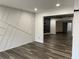 Open living area with decorative accent wall, wood-look flooring, and recessed lighting at 1880 Hays Farm Walk, Marietta, GA 30064