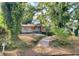 Boarded-up home with overgrown yard and concrete walkway at 244 Morris Brown Nw Ave, Atlanta, GA 30314