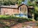 Rundown home with overgrown vines and boarded-up windows and doors at 244 Morris Brown Nw Ave, Atlanta, GA 30314