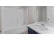Bathroom with white tub/shower combo, white countertop, and navy blue vanity at 2921 Ward Lake Way, Ellenwood, GA 30294