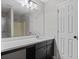 Bathroom vanity with white countertop, black cabinets, and large mirror at 2921 Ward Lake Way, Ellenwood, GA 30294