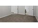 Empty bedroom with plush carpeting, white trim, and white doors at 2921 Ward Lake Way, Ellenwood, GA 30294