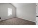 Empty bedroom with vaulted ceiling, single window, and neutral-colored carpeting at 2921 Ward Lake Way, Ellenwood, GA 30294