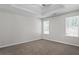 Empty bedroom with carpeted flooring and two large windows at 2921 Ward Lake Way, Ellenwood, GA 30294