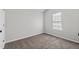 Empty bedroom with vaulted ceiling, neutral carpet, and a single window at 2921 Ward Lake Way, Ellenwood, GA 30294