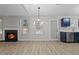 Open and bright dining room with modern light fixture and adjacent blue kitchen at 2921 Ward Lake Way, Ellenwood, GA 30294