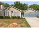 Single-story home with a two-car garage, driveway, and front yard at 2921 Ward Lake Way, Ellenwood, GA 30294