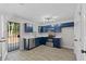 Blue kitchen with stainless steel appliances, white countertops, and door to backyard at 2921 Ward Lake Way, Ellenwood, GA 30294