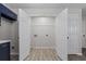 Laundry room with white double doors, washer/dryer hookups, and wood-look flooring at 2921 Ward Lake Way, Ellenwood, GA 30294