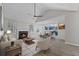 Open concept living room with fireplace, wood-look floors, and adjoining dining area at 2921 Ward Lake Way, Ellenwood, GA 30294