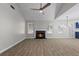 Inviting living room with fireplace, wood-look floors, and vaulted ceiling with fan at 2921 Ward Lake Way, Ellenwood, GA 30294