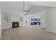 Spacious living room featuring a cozy fireplace, ceiling fan, and wood-look floors at 2921 Ward Lake Way, Ellenwood, GA 30294