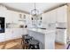 White kitchen with island, breakfast nook, and hardwood floors at 300 Mill Spring Ct, Woodstock, GA 30189