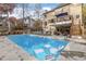 Relaxing pool area with deck, lounge chairs, and covered patio at 300 Mill Spring Ct, Woodstock, GA 30189