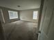 Empty carpeted bedroom with two windows at 5830 Burdett Ridge, Atlanta, GA 30349