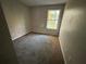 Empty bedroom with carpeted floor and a window at 5830 Burdett Ridge, Atlanta, GA 30349