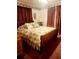 Bedroom with a sleigh bed, burgundy curtains, and floral bedding at 359 Cornish Mtn Rd, Oxford, GA 30054