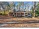 Brick ranch house with a covered porch and large yard at 3515 Panola Rd, Lithonia, GA 30038