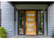 Modern wood front door with glass panels and black frame at 48 Rogers Se St, Atlanta, GA 30317