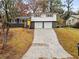 Updated ranch home with gray exterior, yellow door, and two-car garage at 630 El Prado Ct, Stone Mountain, GA 30083