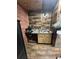 Small basement sink with wood-look countertops at 1824 Smith Store Rd, Covington, GA 30016
