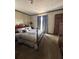 Bedroom with wooden bed frame and carpeted floor at 1824 Smith Store Rd, Covington, GA 30016