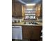Kitchen with wood cabinets, double sink, and window at 1824 Smith Store Rd, Covington, GA 30016