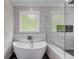 Elegant bathroom with freestanding tub and glass shower enclosure at 2626 Sardis Way, Buford, GA 30519
