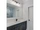 Bathroom with dark vanity, quartz countertop and a large mirror at 2626 Sardis Way, Buford, GA 30519