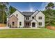 Two-story home with brick and white exterior, a large front yard, and a three-car garage at 2626 Sardis Way, Buford, GA 30519