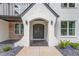 Elegant front entry with a black arched double door and white brick columns at 2626 Sardis Way, Buford, GA 30519