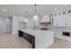 Spacious kitchen featuring a large island with white quartz countertops and dark cabinetry at 2626 Sardis Way, Buford, GA 30519