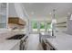Modern kitchen features a large island, stainless steel appliances, and white cabinetry at 2626 Sardis Way, Buford, GA 30519