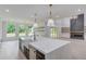 Bright kitchen boasts a spacious island with white quartz countertops and high-end fixtures at 2626 Sardis Way, Buford, GA 30519