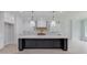 Modern kitchen with white and dark cabinets, quartz countertops, and a large island at 2626 Sardis Way, Buford, GA 30519